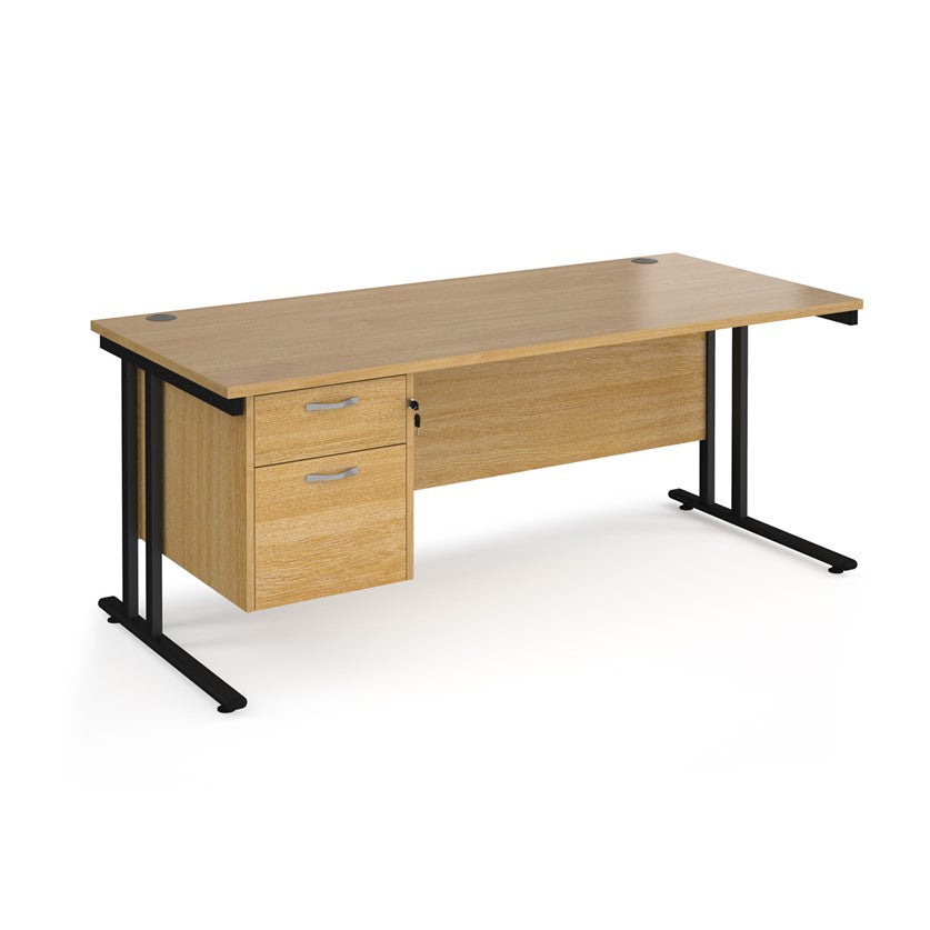 Rectangular office desk with a cantilever frame and a beige two-drawer fixed pedestal. The desk has a melamine finish and is pictured against a white background.
