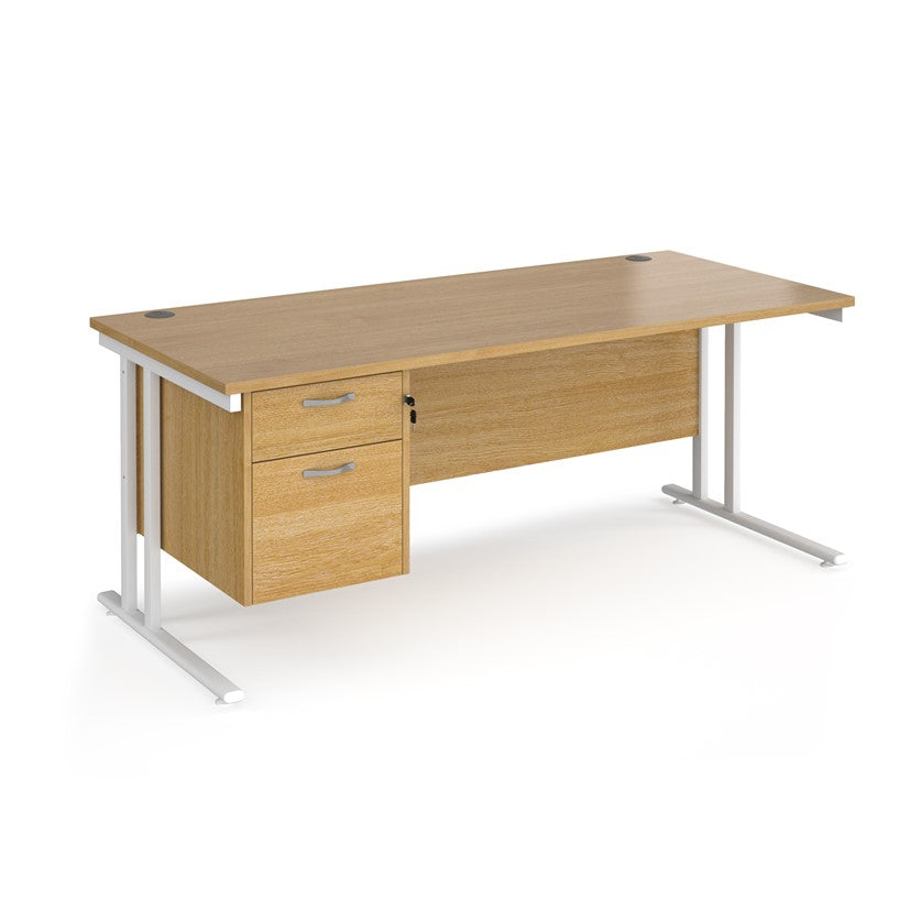 Rectangular office desk with a cantilever frame and a beige two-drawer fixed pedestal. The desk has a melamine finish and is pictured against a white background.
