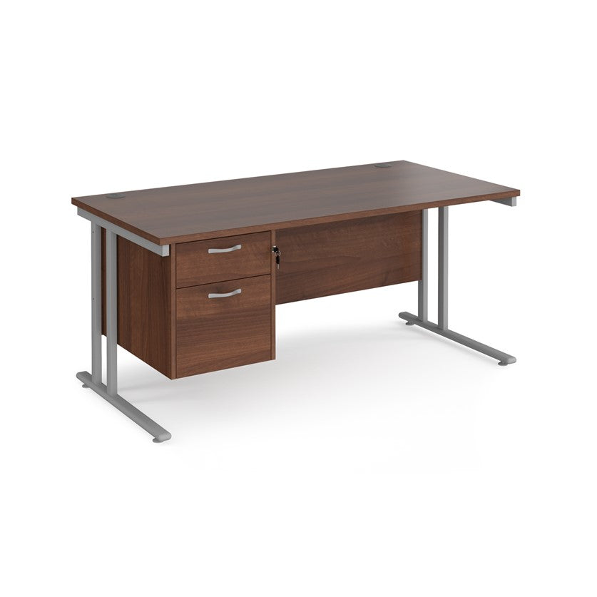 Rectangular office desk with a cantilever frame and a beige two-drawer fixed pedestal. The desk has a melamine finish and is pictured against a white background.
