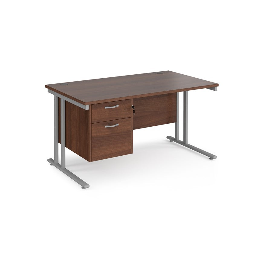Rectangular office desk with a cantilever frame and a beige two-drawer fixed pedestal. The desk has a melamine finish and is pictured against a white background.