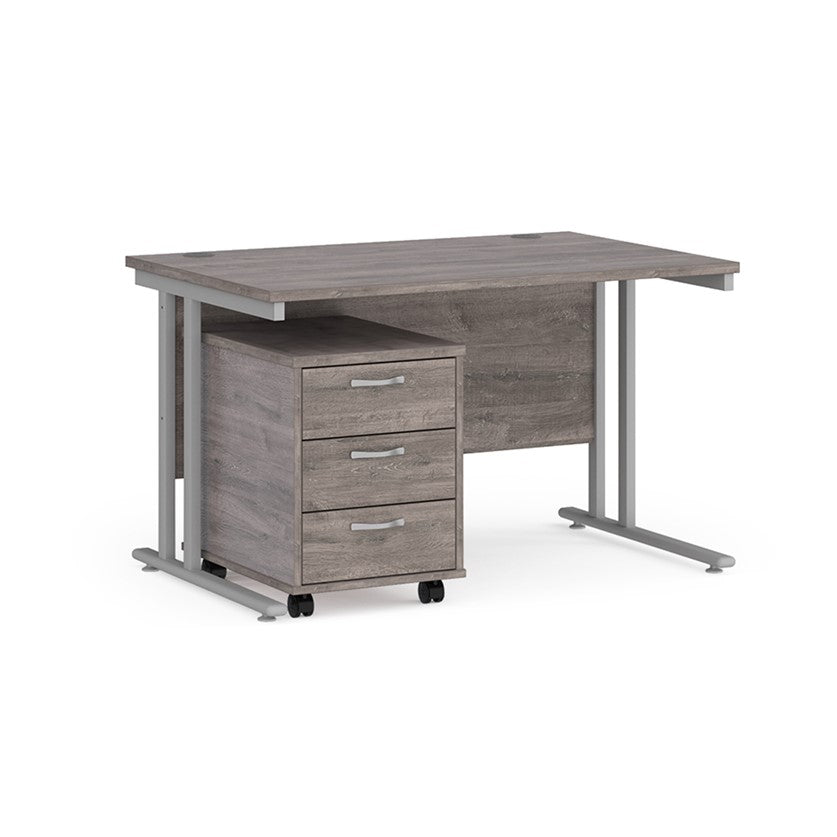 A Grey Oak finish desk with a 3 drawer pedestal bundle on a white background