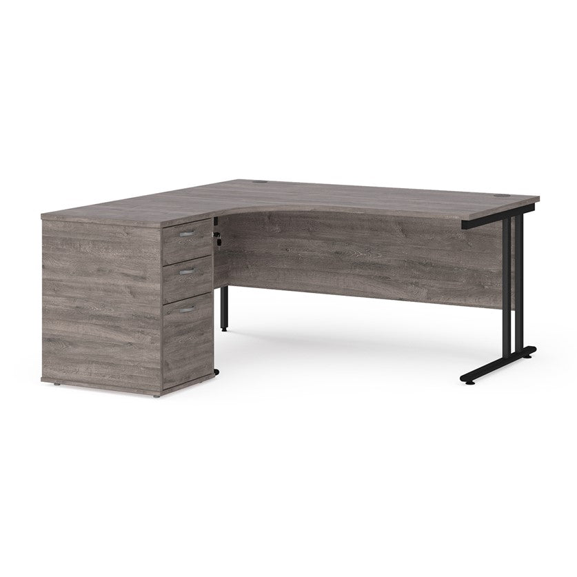 A left-hand corner desk with a cantilever frame and a grey melamine desktop, featuring a pedestal with two drawers.