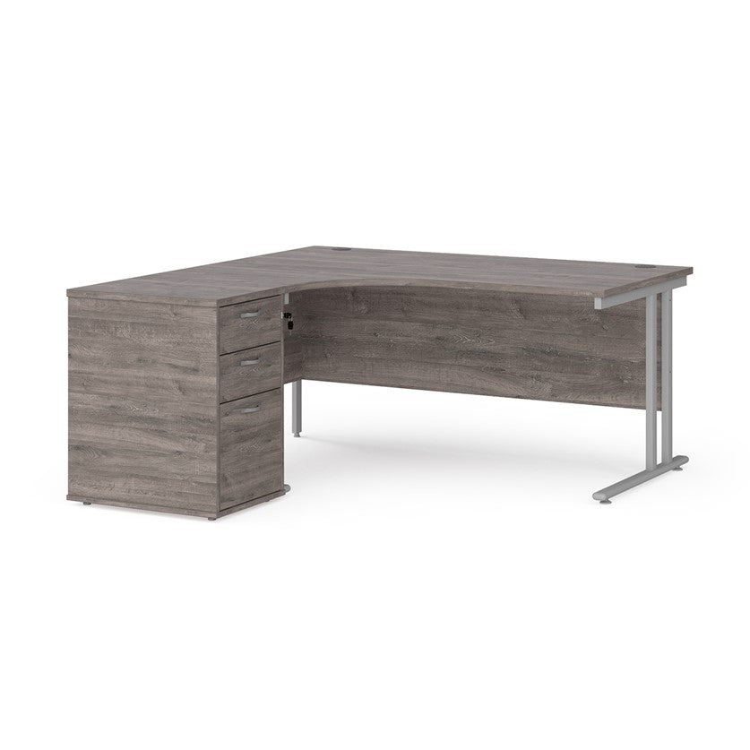 A left-hand corner desk with a cantilever frame and a Grey melamine desktop, featuring a pedestal with two drawers.
