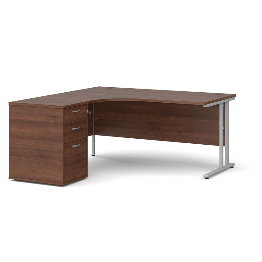 A left-hand corner desk with a cantilever frame and a Walnut melamine desktop, featuring a pedestal with two drawers.
