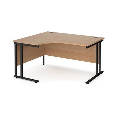 A left hand ergonomic desk with a cantilever frame made of metal and a wooden desktop, positioned against a white background.