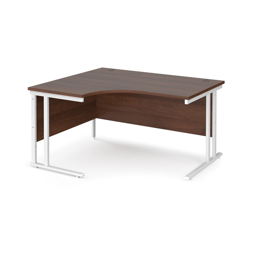 A left hand desk in walnut finish with white legs. 
