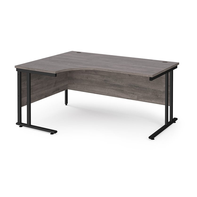 A left hand desk in grey finish with black metal legs. 