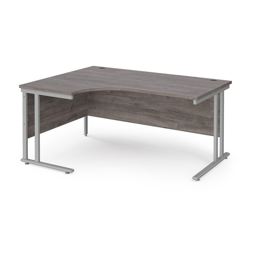 A left hand desk in grey finish with grey metal legs.