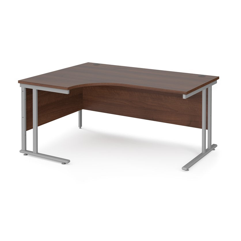 A left hand desk in walnut finish with grey metal legs.
