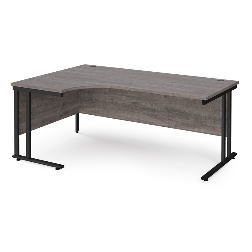 A left hand desk in grey finish with black metal legs.