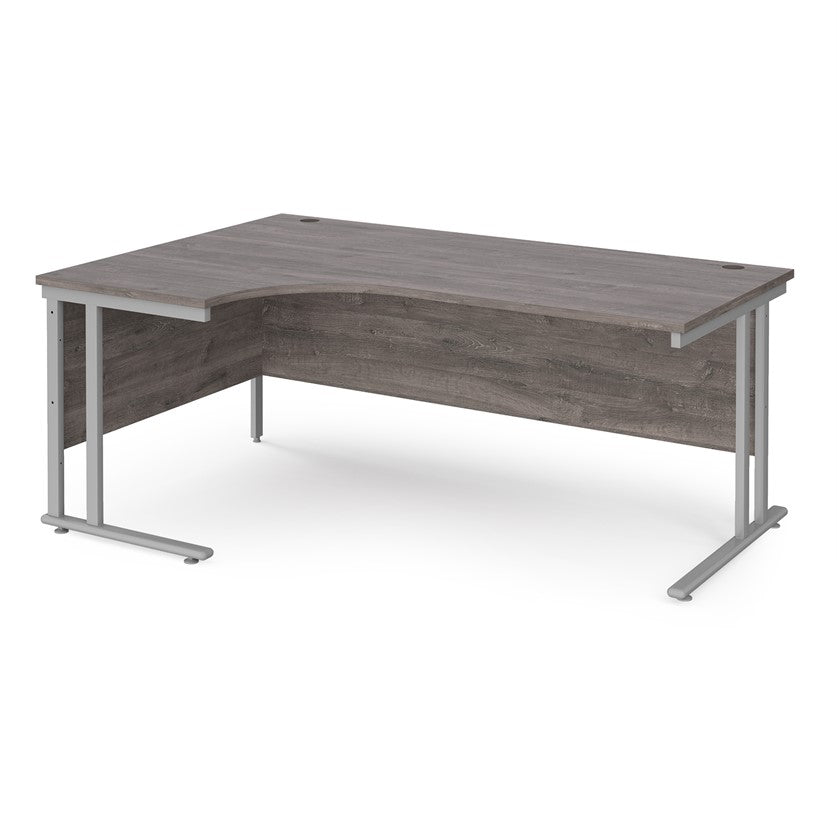 A left hand desk in grey finish with grey metal legs. 