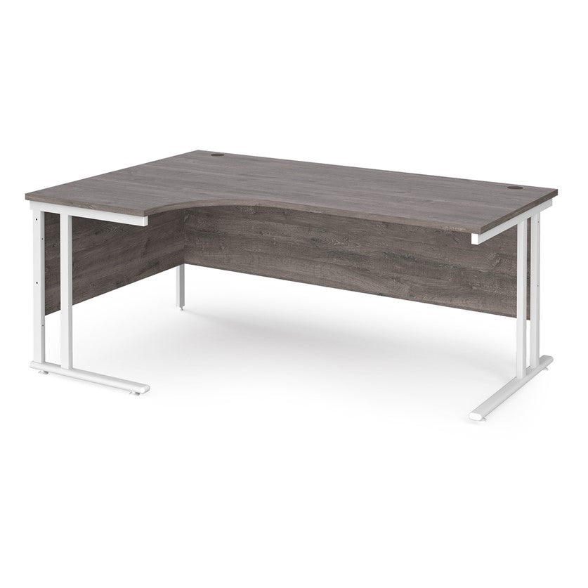 A left hand desk in grey finish with white metal legs.