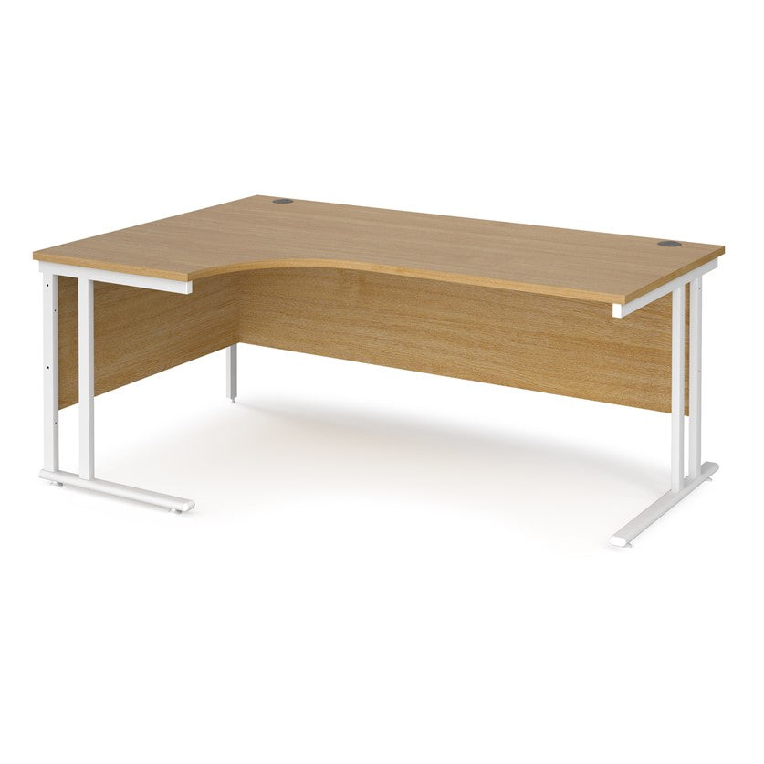 A left hand desk in oak finish with white metal legs.