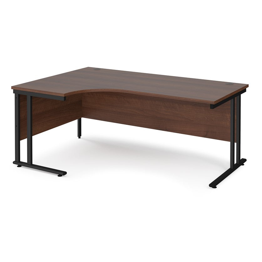 A left hand desk in walnut finish with black metal legs. 