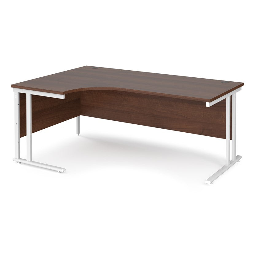 A left hand desk in walnut finish with white metal legs. 