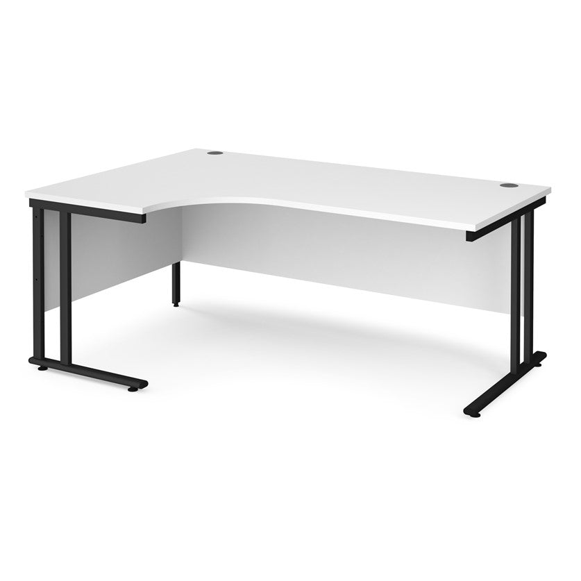 A left hand desk in white with black metal legs.