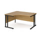 A left hand ergonomic desk with a cantilever frame made of metal and a wooden desktop, positioned against a white background.