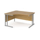 A left hand ergonomic desk with a cantilever frame made of metal and a wooden desktop, positioned against a white background.