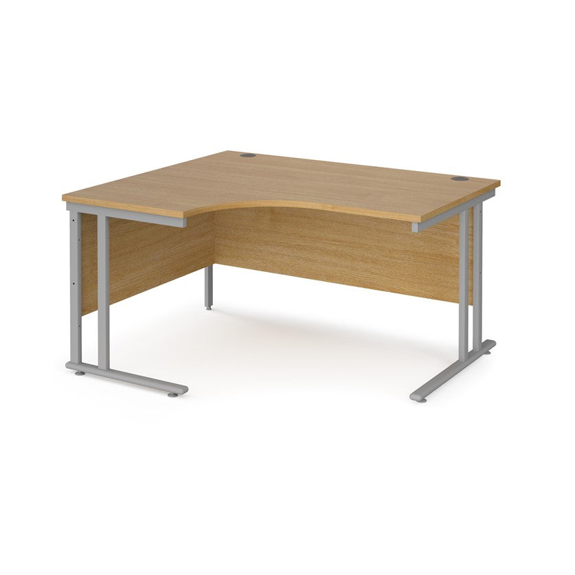 A left hand ergonomic desk with a cantilever frame made of metal and a wooden desktop, positioned against a white background.