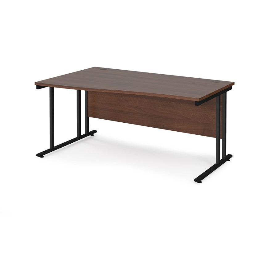 A rectangular office desk with a walnut tabletop and black cantilever metal legs.
