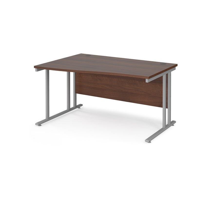 A rectangular office desk with a walnut melamine tabletop and cantilever metal legs.
