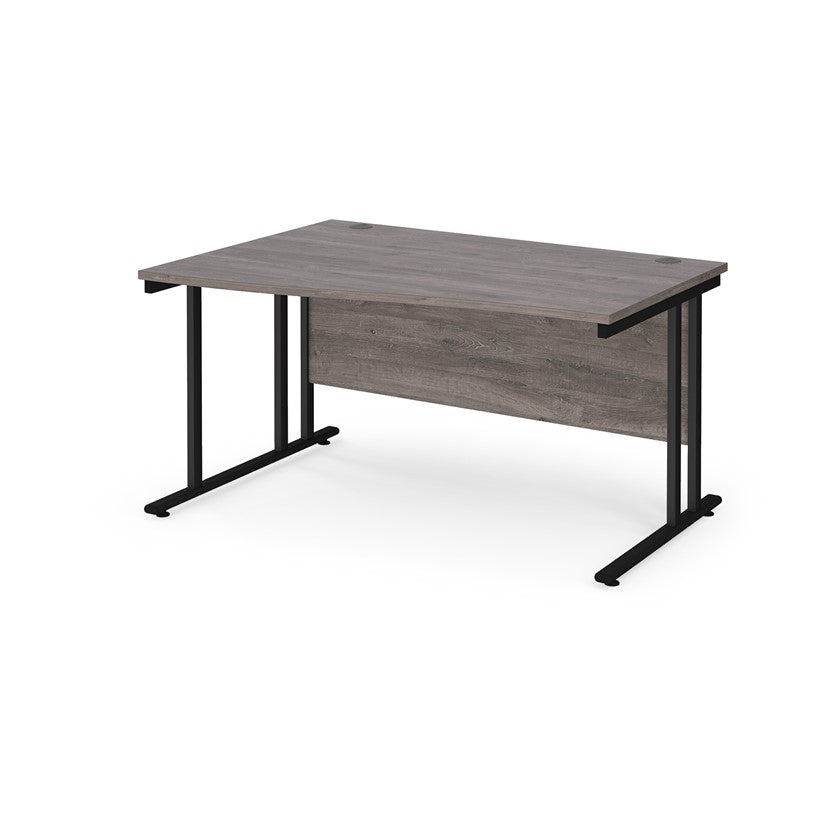 A rectangular office desk with a grey melamine tabletop and black cantilever metal legs.