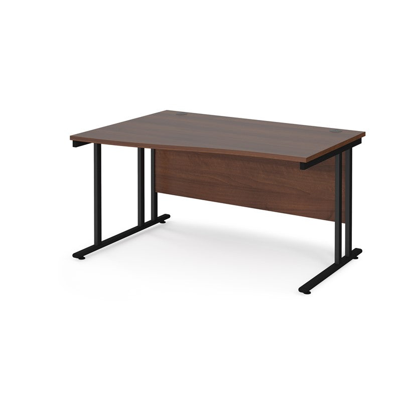 A rectangular office desk with a walnut melamine tabletop and black cantilever metal legs.
