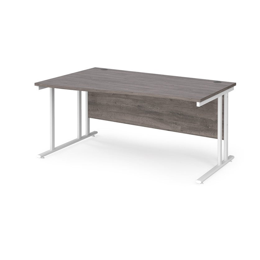 A rectangular office desk with a grey melamine tabletop and cantilever metal legs.
