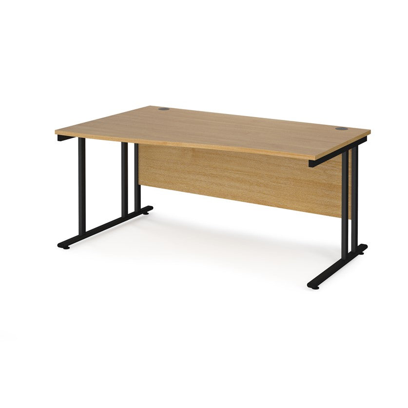 A rectangular office desk with a beige melamine tabletop and black cantilever metal legs.
