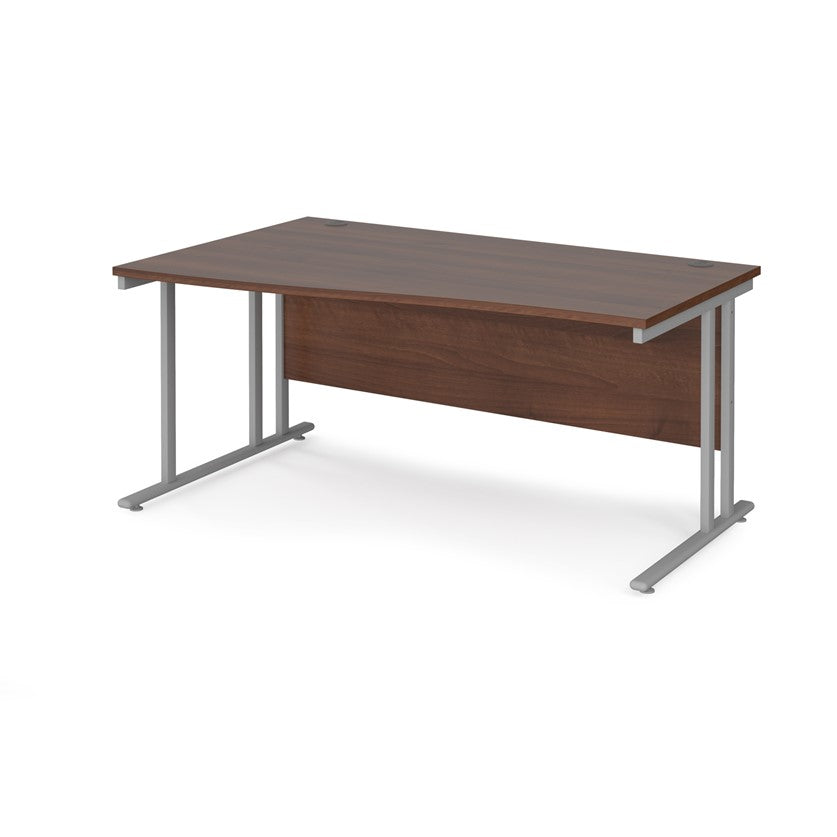 A rectangular office desk with a walnut tabletop and cantilever metal legs.
