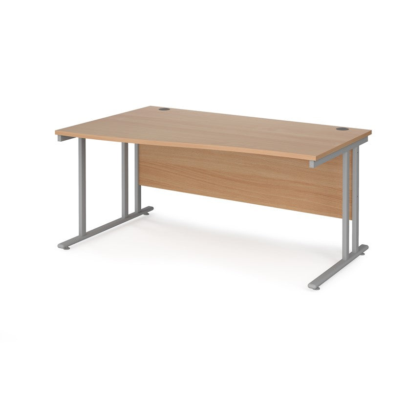A rectangular office desk with a beige melamine tabletop and grey cantilever metal legs.
