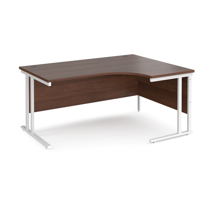 A right-hand ergonomic desk with a walnut melamine tabletop and white cantilever metal frame.