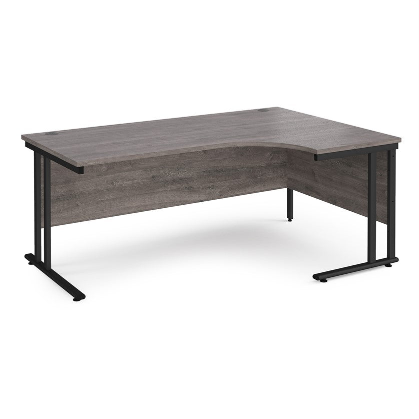 A right-hand ergonomic desk with a grey melamine tabletop and black cantilever metal frame.