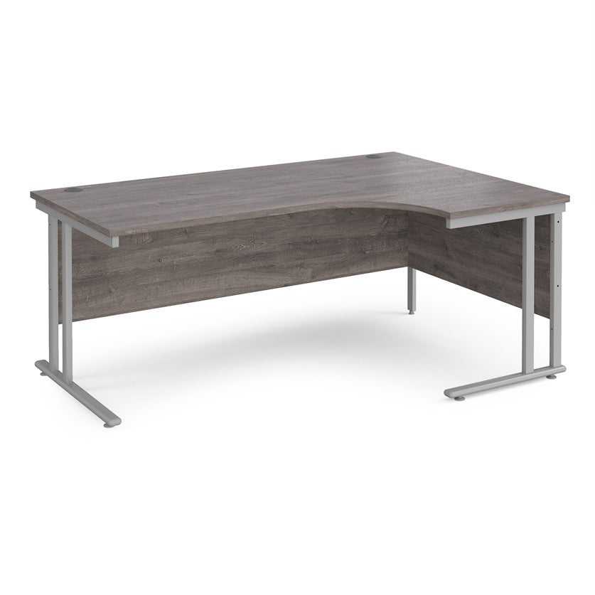 A right-hand ergonomic desk with a grey melamine tabletop and grey cantilever metal frame.