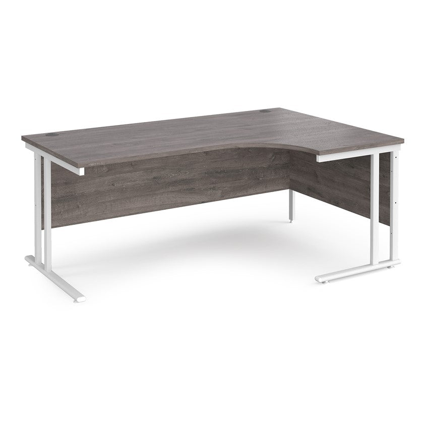 A right-hand ergonomic desk with a grey melamine tabletop and white cantilever metal frame.