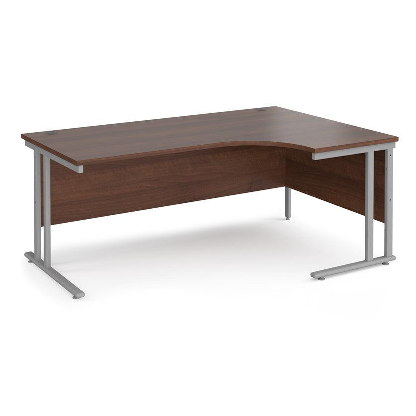 A right-hand ergonomic desk with a walnut melamine tabletop and cantilever metal frame.