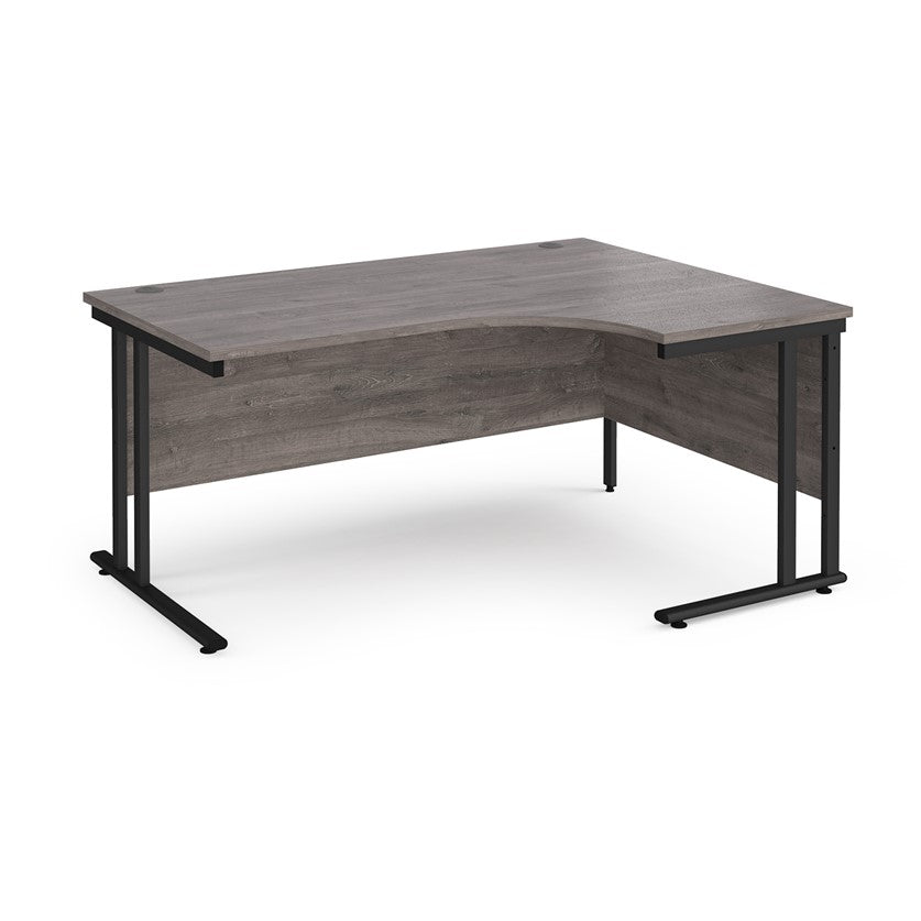 A right-hand ergonomic desk with a grey melamine tabletop and black cantilever metal frame.