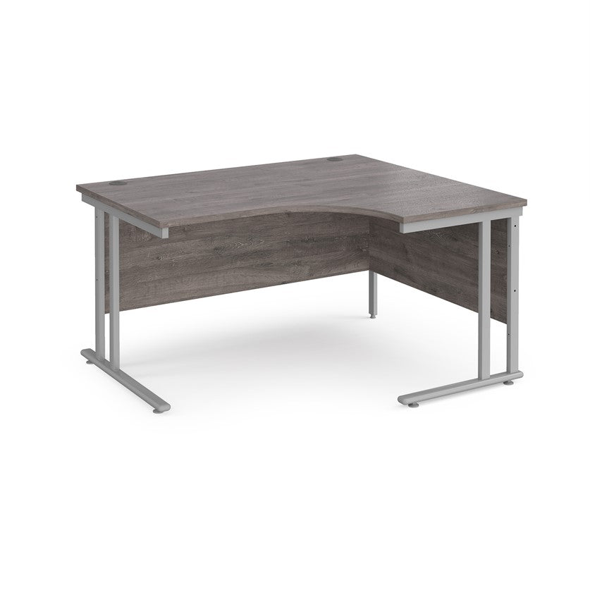 A right-hand ergonomic desk with a grey melamine tabletop and cantilever metal frame.