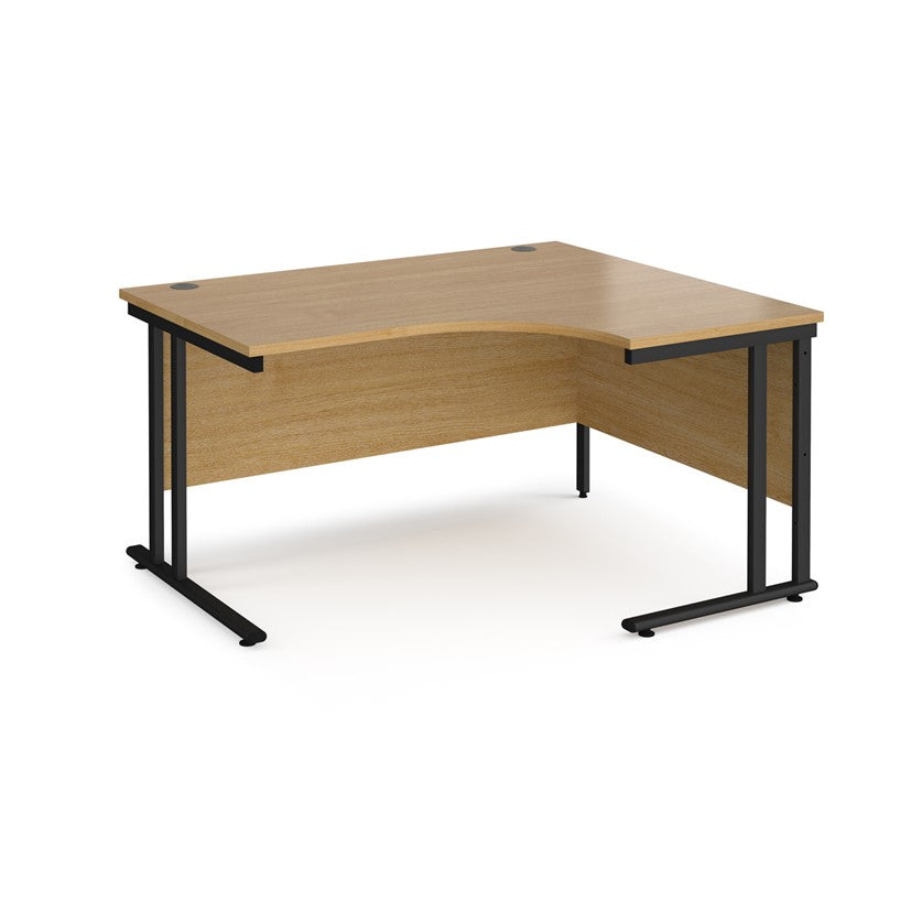 A right-hand ergonomic desk with a brown melamine tabletop and black cantilever metal frame.