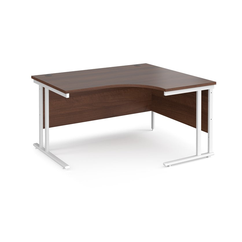A right-hand ergonomic desk with a walnut melamine tabletop and white cantilever metal frame.