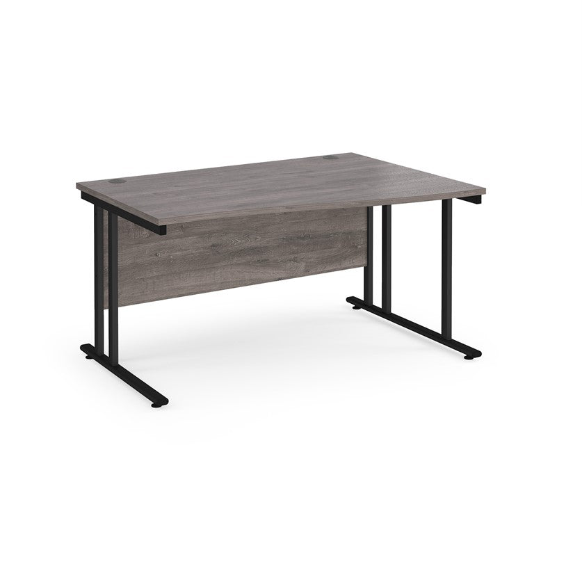 A rectangular office desk with a grey melamine tabletop and black cantilever metal legs.