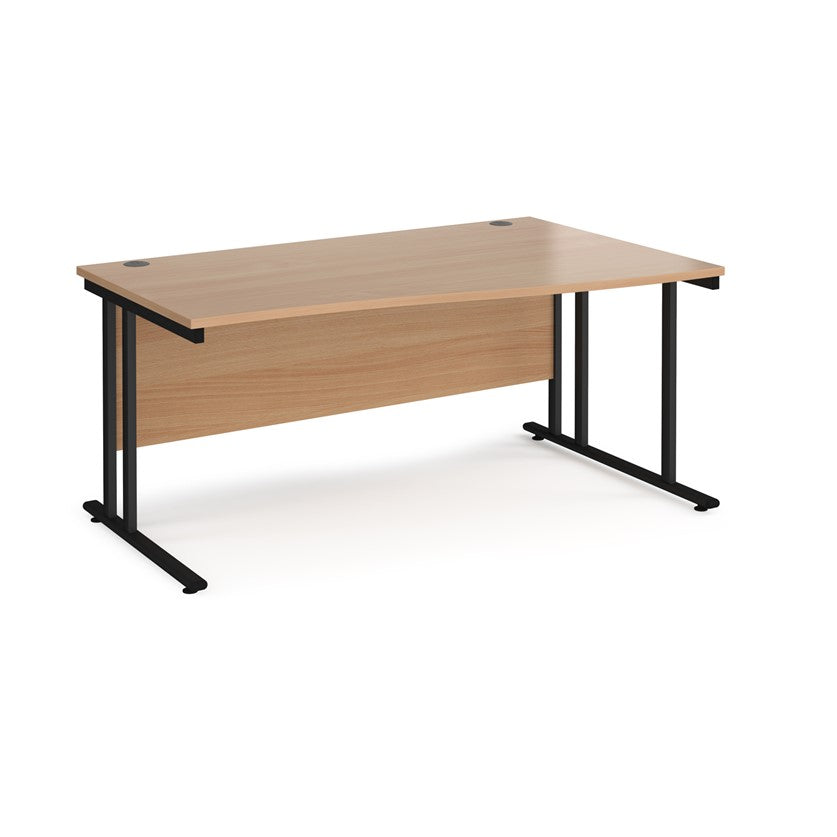 A rectangular office desk with a beige melamine tabletop and black cantilever metal legs.
