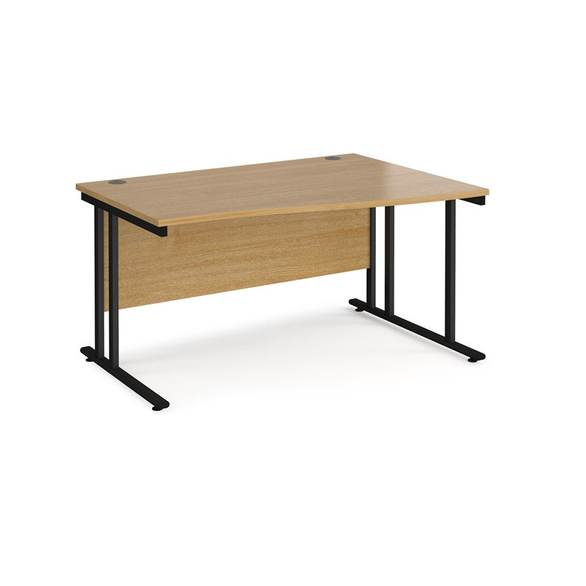 A rectangular office desk with a beige melamine tabletop and black cantilever metal legs.