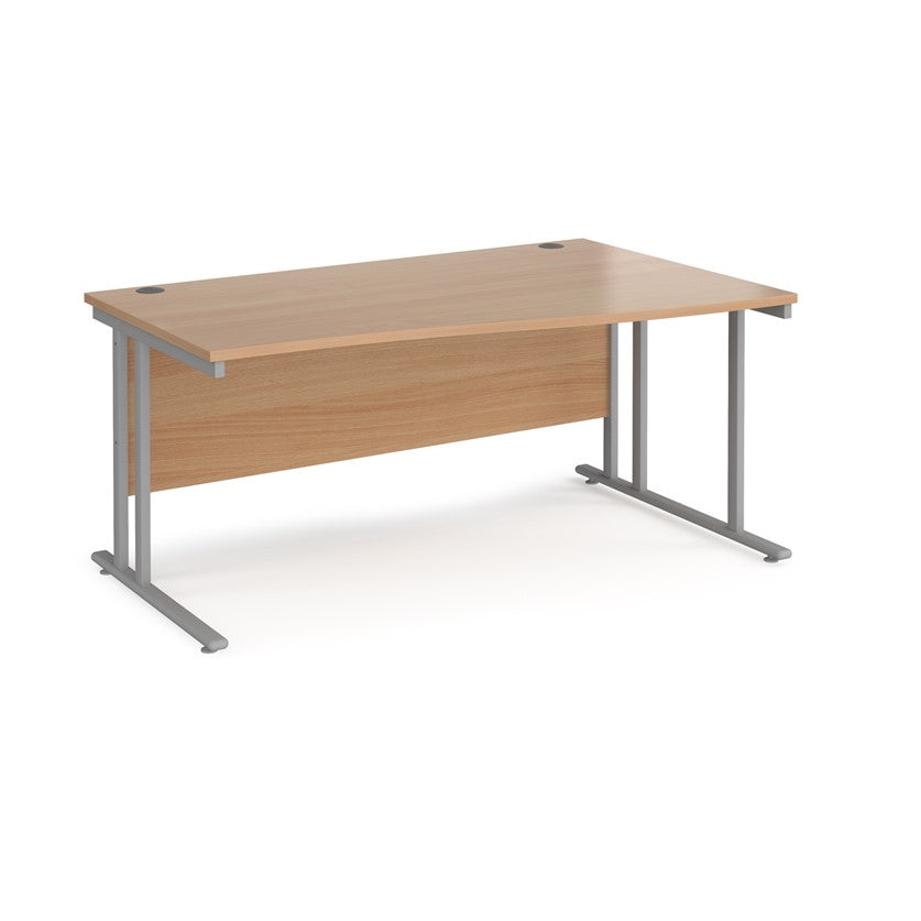 A rectangular office desk with a beige melamine tabletop and grey cantilever metal legs.
