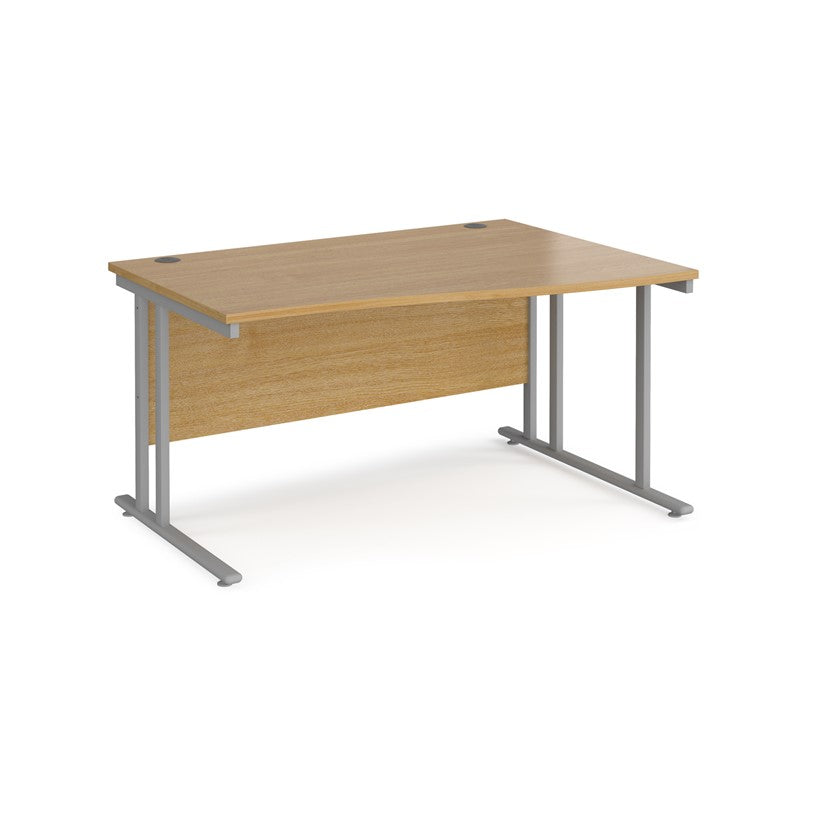 A rectangular office desk with a beige melamine tabletop and cantilever metal legs.