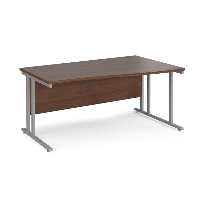 A rectangular office desk with a walnut melamine tabletop and grey cantilever metal legs.
