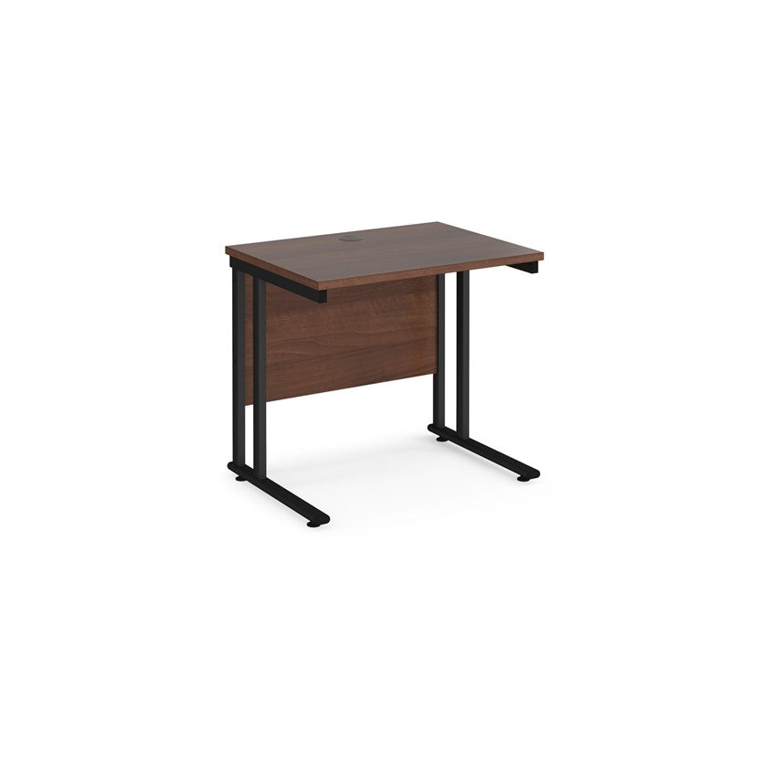 A rectangular office desk with a black cantilever frame and a walnut melamine desktop, featuring one cable access port.