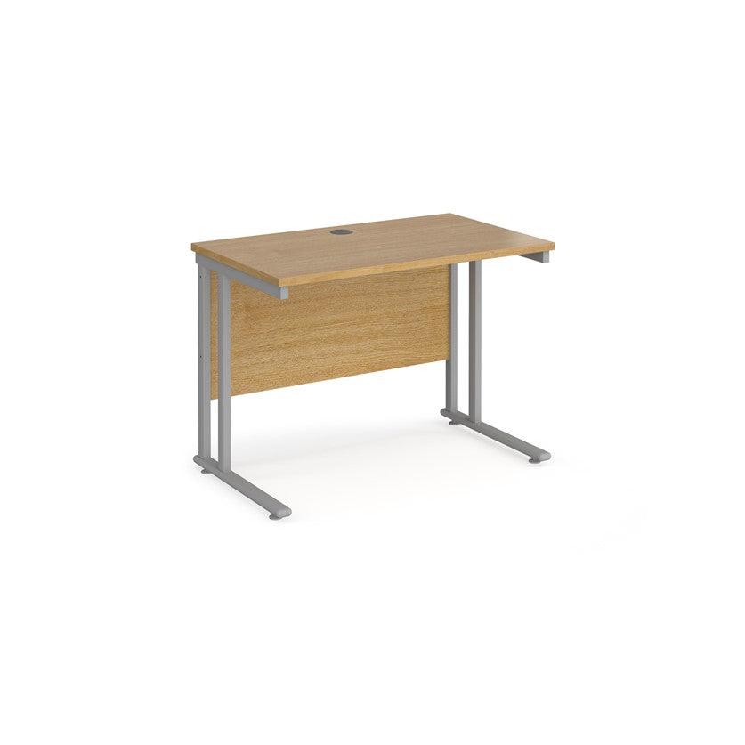 An oak desk with a grey cantilever frame.