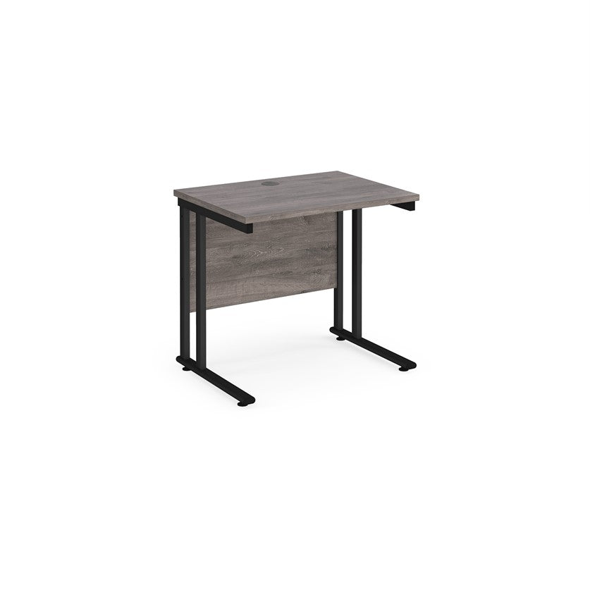 A rectangular office desk with a black cantilever frame and a grey melamine desktop, featuring one cable access port.