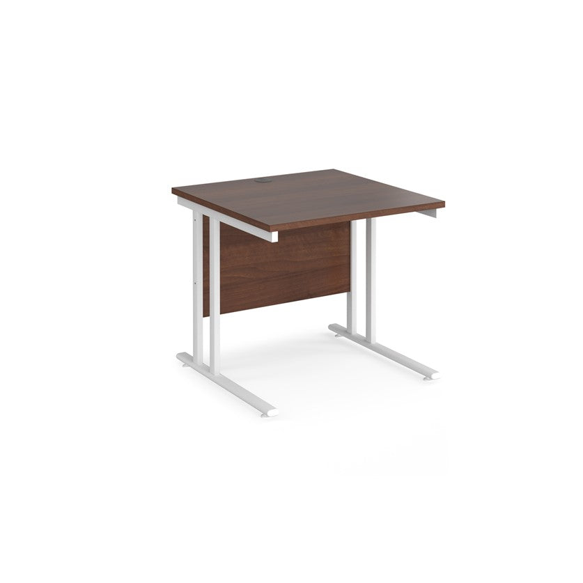 A rectangular desk in walnut with a white cantilever frame. 
